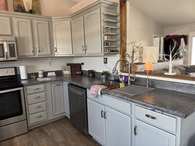 kitchen featuring tasteful backsplash, sink, dark hardwood / wood-style floors, and appliances with stainless steel finishes