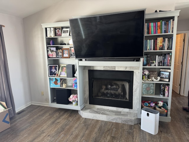 living room with wood-type flooring and vaulted ceiling