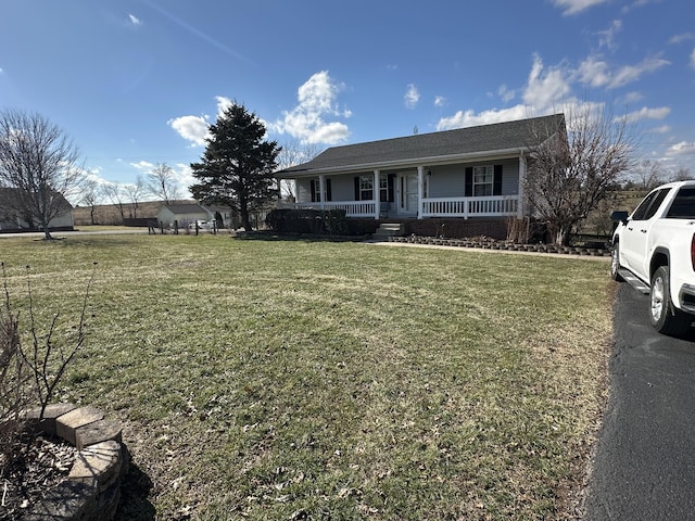 view of front of property featuring covered porch and a front lawn