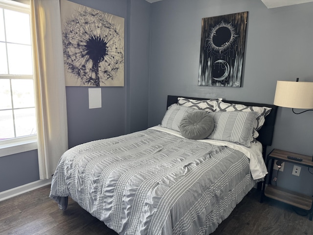 bedroom with dark hardwood / wood-style flooring