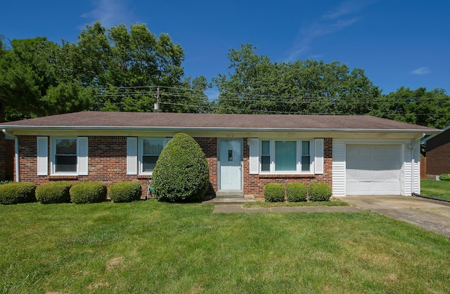 single story home featuring a garage and a front yard