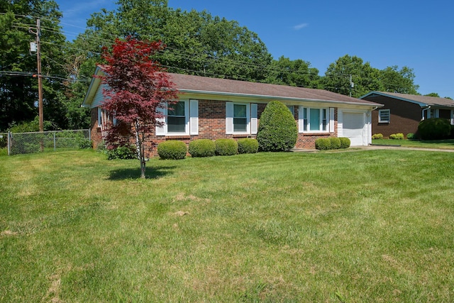 single story home with a garage and a front lawn