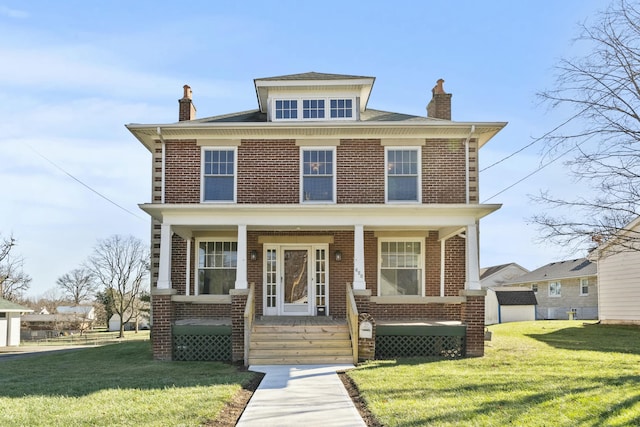 view of front of house featuring a front lawn, a storage unit, and a porch