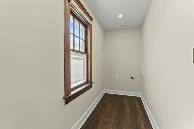 laundry room featuring dark hardwood / wood-style floors and electric dryer hookup