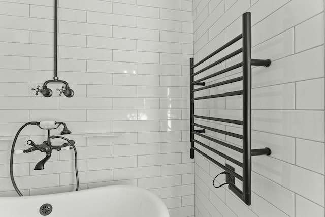 bathroom featuring radiator heating unit and a bathing tub