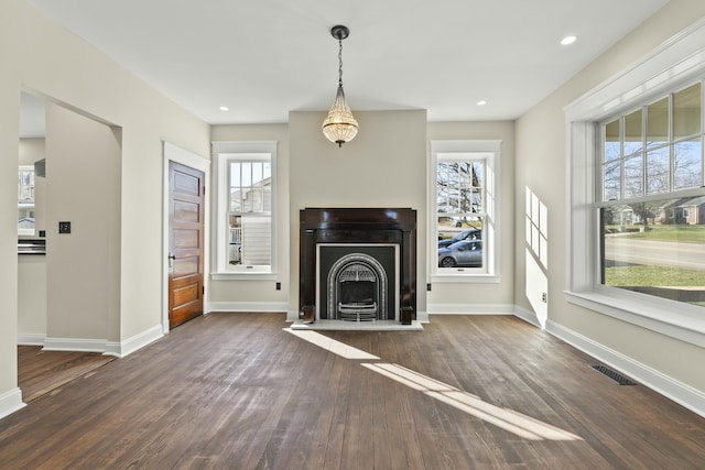 unfurnished living room with dark hardwood / wood-style floors