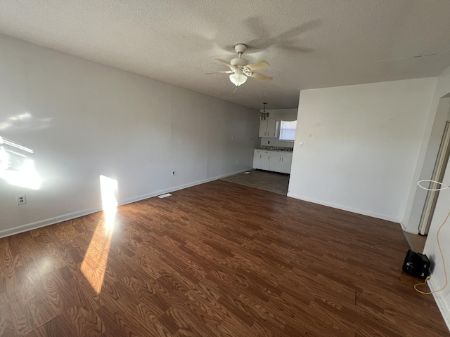 346 Becks Creek Rd, Williamsburg, KY 40769 - unfurnished living room featuring ceiling fan, dark wood-type flooring, and a textured ceiling
