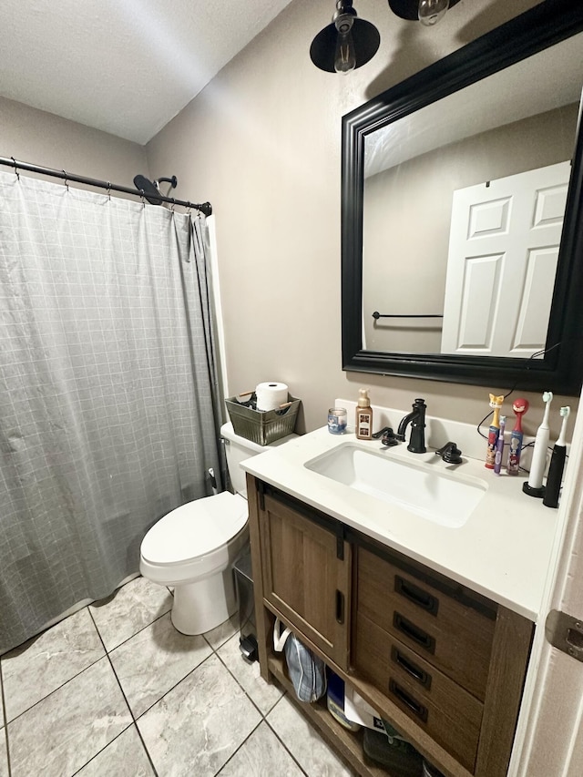 bathroom with a shower with curtain, vanity, tile patterned floors, and toilet