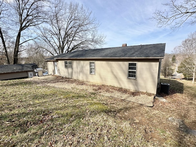 view of property exterior featuring central AC and a yard