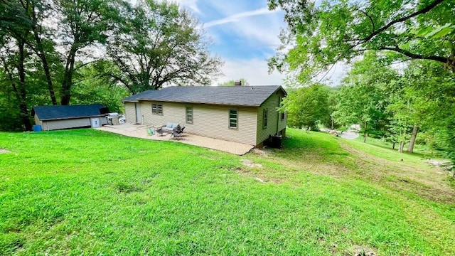 rear view of house with a patio and a lawn