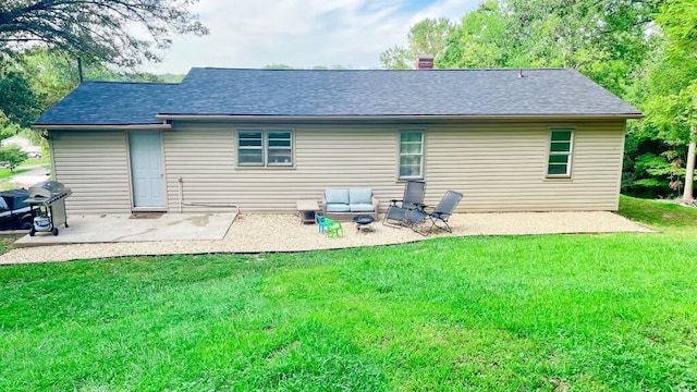 rear view of property with a yard and a patio area