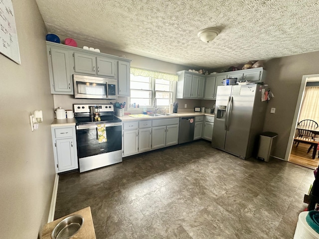 kitchen featuring sink, a textured ceiling, and appliances with stainless steel finishes