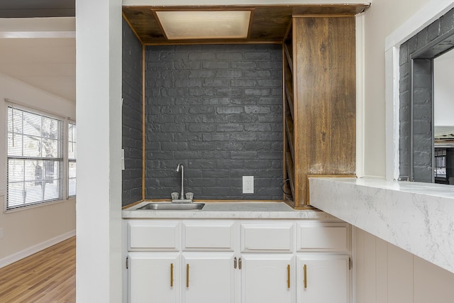 kitchen featuring light hardwood / wood-style floors, sink, and white cabinets