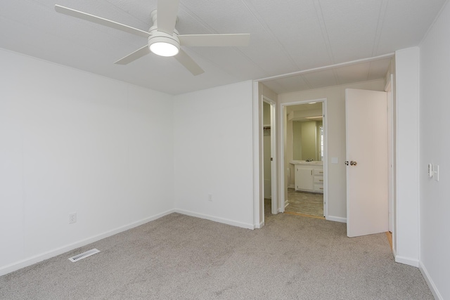 carpeted empty room with ceiling fan