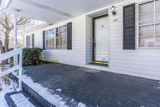 view of snow covered property entrance