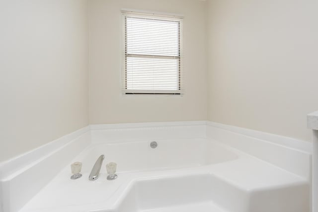 bathroom featuring a tub and vanity