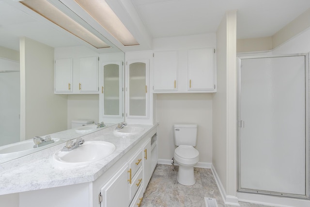 bathroom with toilet, a shower with shower door, and vanity