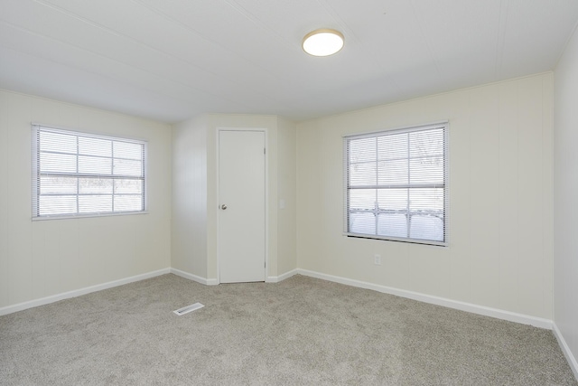 empty room featuring light colored carpet