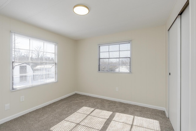 unfurnished bedroom featuring a closet and light carpet