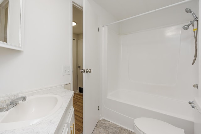 full bathroom featuring washtub / shower combination, vanity, and toilet