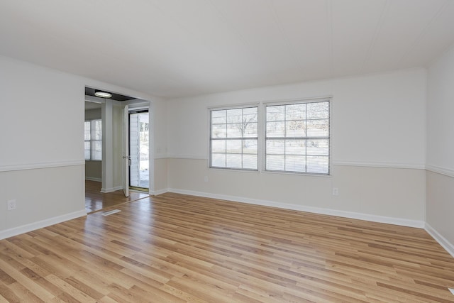 spare room featuring light wood-type flooring