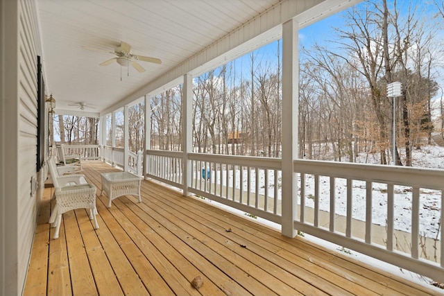 unfurnished sunroom with ceiling fan