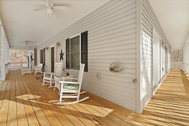 wooden deck with covered porch and ceiling fan