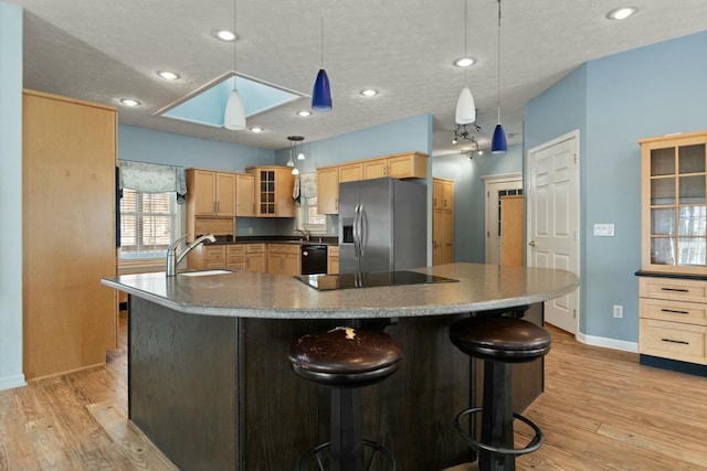 kitchen with sink, pendant lighting, light brown cabinets, and black appliances