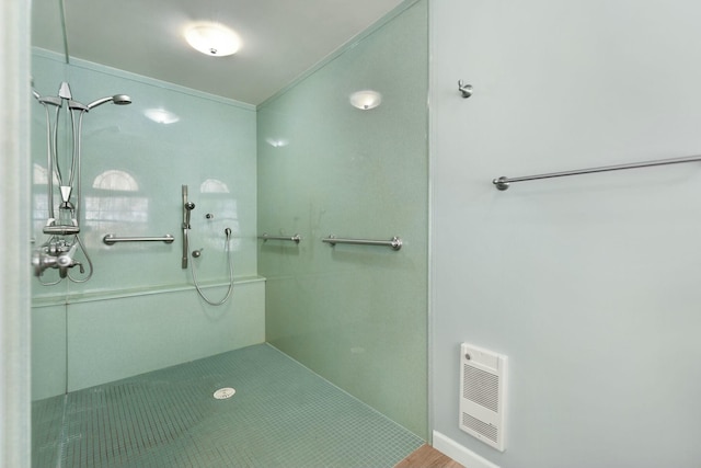 bathroom with heating unit and walk in shower