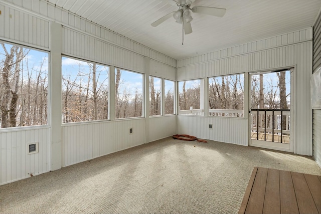 unfurnished sunroom with ceiling fan