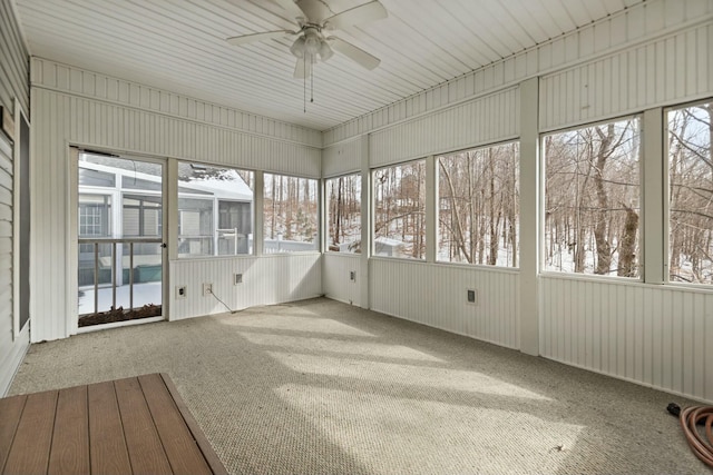 unfurnished sunroom with ceiling fan