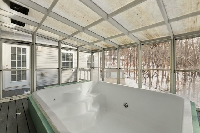 unfurnished sunroom featuring a jacuzzi and coffered ceiling