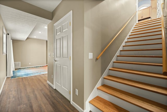 stairs featuring hardwood / wood-style flooring