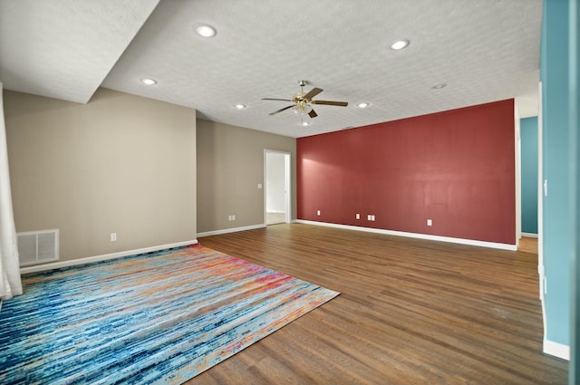 unfurnished room with ceiling fan, hardwood / wood-style floors, and a textured ceiling