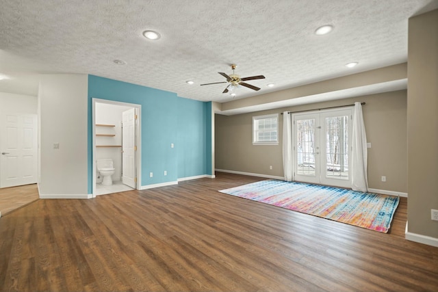 interior space with hardwood / wood-style floors, a textured ceiling, and french doors