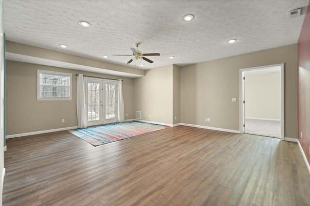 interior space featuring hardwood / wood-style flooring, ceiling fan, a textured ceiling, and french doors