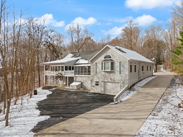 exterior space with a garage and a sunroom