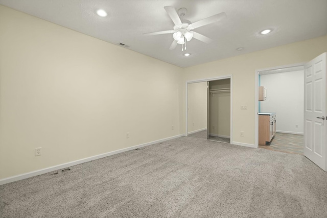 unfurnished bedroom featuring carpet flooring, a closet, and ceiling fan