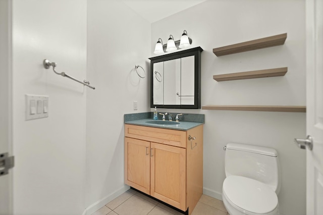 bathroom with vanity, toilet, and tile patterned floors