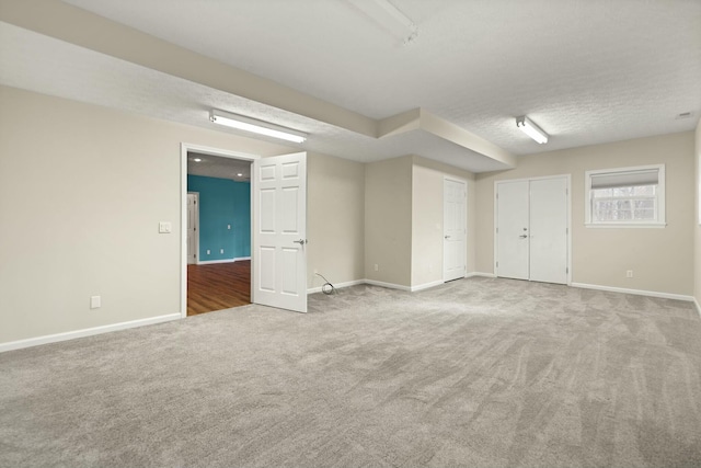 carpeted spare room with a textured ceiling