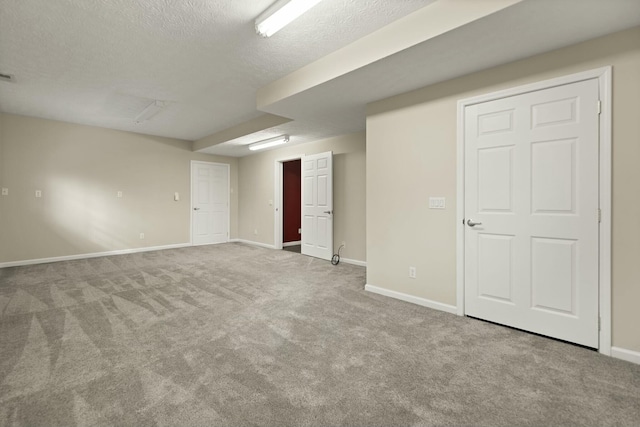 basement with a textured ceiling and carpet floors