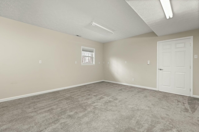 spare room with carpet and a textured ceiling