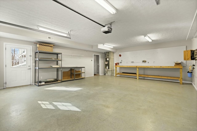 garage with a workshop area and a garage door opener