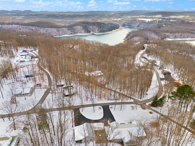 snowy aerial view with a water and mountain view