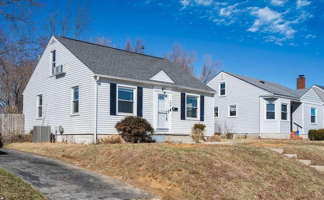 view of front of property with cooling unit and a front lawn