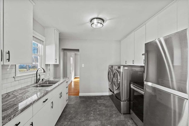 laundry area with sink and washer and clothes dryer