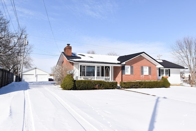 view of front of home with a garage, an outdoor structure, and a porch