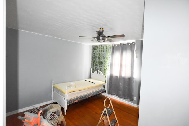 bedroom with wood-type flooring and ceiling fan