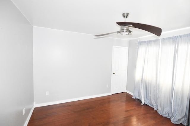 spare room with ceiling fan and dark hardwood / wood-style flooring