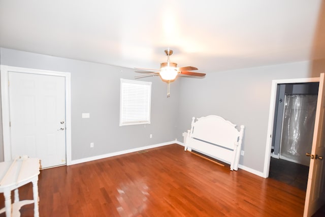 unfurnished bedroom with dark hardwood / wood-style floors and ceiling fan